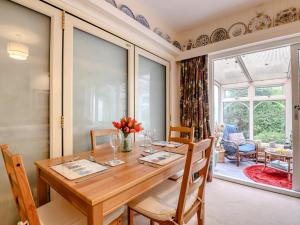 a dining room with a wooden table and chairs at 2 Bed in Coleford 60103 in Coleford
