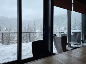 a room with a view of a snow covered mountain at Vila Relax in Donovaly