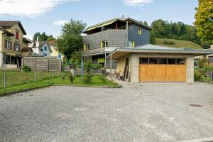 a house with a garage in front of it at Kronenwiese in Mosnang