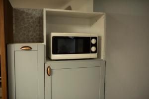 a microwave sitting on top of a refrigerator at Apartament 33 Skawina in Skawina