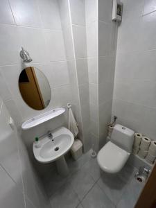 a bathroom with a toilet and a sink and a mirror at Pensjonat Malinówka in Szczyrk