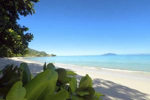 a view of a beach with trees and the ocean at Beach View Villa - Beauvallon villas in Beau Vallon