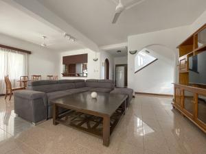 a living room with a couch and a table at Beach View Villa - Beauvallon villas in Beau Vallon