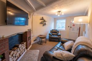 a living room with a couch and a fireplace at Town Centre Cottage 3 Bedroom inc Parking (1 car) in Shrewsbury