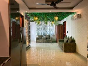 a living room with chairs and a ceiling with plants at Rabha Stay 2BHK Penthouse with Terrace in Rishīkesh