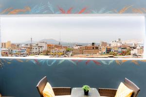 a table with chairs and a view of a city at Hotel Viera Chimbote in Chimbote