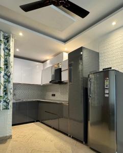 a kitchen with a ceiling fan and a refrigerator at Rabha Stay 2BHK Penthouse with Terrace in Rishīkesh