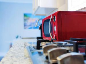 a red appliance sitting on top of a table at Elegant 1Bed Montrose-CinqueTerre@TheItalianPlaza in Houston
