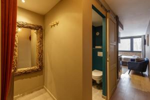 a bathroom with a toilet and a mirror at Beautiful mountain view studio by the lake in Chamonix-Mont-Blanc