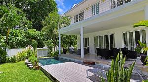 a house with a swimming pool in the yard at Villa Blanc - Chateau Elysium in Beau Vallon