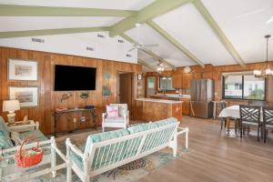 a living room with wood paneling and a flat screen tv at Fripp Island 702 Tautog in Fripp Island