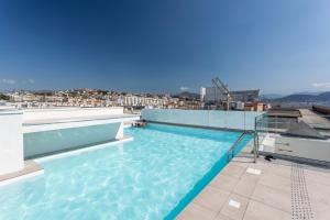 a swimming pool on the roof of a building at Nemea Appart Hotel Nice Arenas Aéroport in Nice