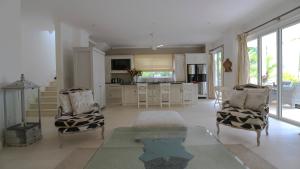 a large living room with a table and chairs at Les Jolies Eaux Villa - Chateau Elysium in Beau Vallon