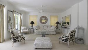 a living room with a couch and two chairs at Les Jolies Eaux Villa - Chateau Elysium in Beau Vallon +7 photos