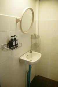 a bathroom with a sink and a mirror at Big Elk Steak House - HomeStay in Trat