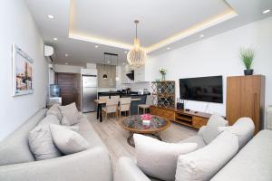 a living room with white furniture and a dining room at Maldives Holiday Homes in Kyrenia