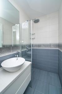 a white bathroom with a sink and a shower at Maldives Holiday Homes in Kyrenia
