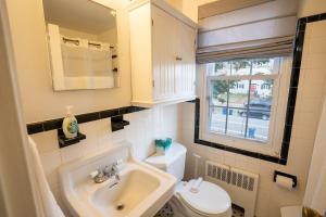 a bathroom with a sink and a toilet and a window at Perfect For Families That Want To Be Close To Dc in Alexandria