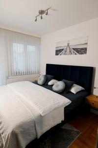 a bedroom with a large bed with pillows on it at Studio apartman Aurora in Đakovo
