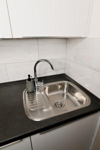 a stainless steel sink in a small kitchen at Studio apartman Aurora in Đakovo