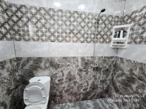 a bathroom with a toilet and a shower at Entire home in Ganja in Ganja