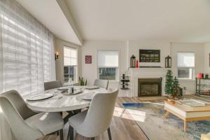 a dining room with a table and chairs and a fireplace at Dog-Friendly Rochester Home about 3 Mi to Downtown! in Rochester