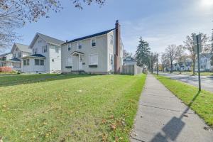a residential street with houses and a sidewalk at Dog-Friendly Rochester Home about 3 Mi to Downtown! in Rochester