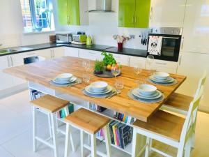 a kitchen with a wooden table with plates on it at 2 bed property in Llandysul 77655 in Llangynllo
