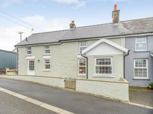 a white house on the side of a street at 2 bed property in Llandysul 77655 in Llangynllo