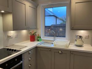 a kitchen with a sink and a window at 4 Bed in Brodick CA381 in Brodick