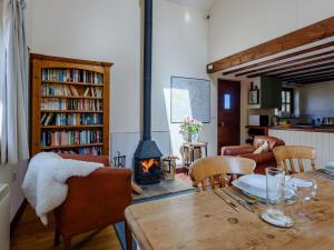 a living room with a table and a fireplace at 2 Bed in Presteigne 75066 in Whitton