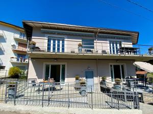 a house with tables and chairs on a balcony at Appartamenti Golfo Borromeo 3 e 4 Baveno in Baveno