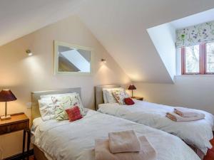 two beds in a attic room with a window at 2 Bed in Presteigne 75066 in Whitton
