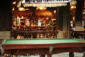 a pool table in a restaurant with a bar at Big Elk Steak House - HomeStay in Trat