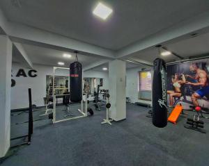 a gym with two people in a room with weights at Gold Apartmani Kozarac in Kozarac