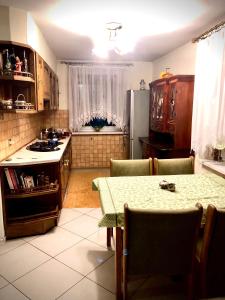 a kitchen with a table and a kitchen with a refrigerator at Domek w Glince in Ujsoły
