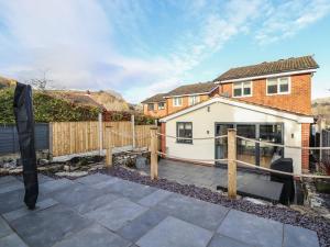 a view of a house with a fence at 25 Maes Collen in Llangollen