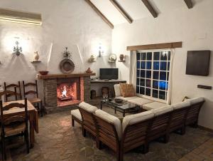 a living room with a couch and a fireplace at Casa Zahora in Zahora