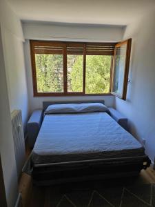 a bedroom with a bed and a window at Bella vista in Limone Piemonte