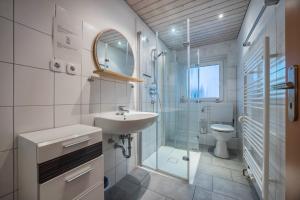 a bathroom with a sink and a shower and a toilet at Gästeapartment Hannover in Hannover +13 photos