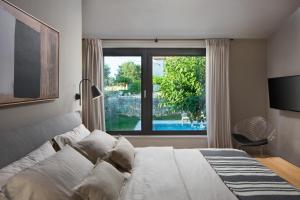 a bedroom with a bed and a large window at Modern Villa Melon with outdoor pool in Porec in Krmenjak +36 photos