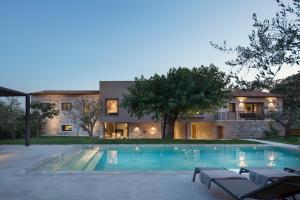 a house with a swimming pool in front of a house at Modern Villa Melon with outdoor pool in Porec in Krmenjak