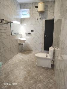 a bathroom with a toilet and a sink at MIRRA ALFASSA VILLA in Auroville +19 photos