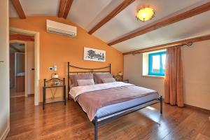 a bedroom with a large bed in a room at Rustic Villa Simone with outdoor pool in Porec in Krmenjak +38 photos