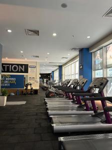a gym with a row of treadmills and machines at Peak Perspective 32nd Floor Apartment Spa&Fitness Access in Skopje
