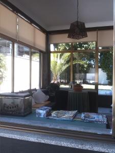 a living room with a table and some windows at Gardenia Residence in Braga