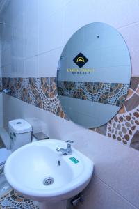 a bathroom with a sink and a mirror on the wall at Jalde Heights, Limuru Road, 178, Nairobi City, Nairobi, Kenya in Nairobi