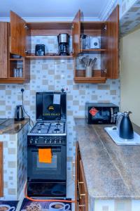 a kitchen with a black stove top oven at Jalde Heights, Limuru Road, 178, Nairobi City, Nairobi, Kenya in Nairobi