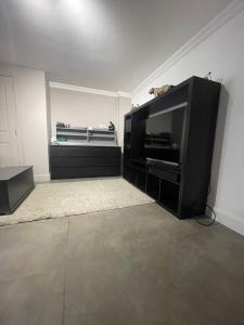 a living room with a flat screen tv in a room at 50A Green Lane in Cranford