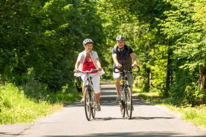 two people riding bikes down a road at Landhotel Napoleon in Wipperfürth